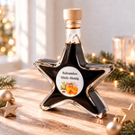 Aceto Miele-Honig Creme Sternflasche Feinkost-Geschenkflasche im festlichen Ambiente – Geschenkidee Sternflasche Feinkost-Geschenkflasche mit cremigem Aceto Balsamico IGP mit feinem Bienenhonig (3% Säure) in weihnachtlicher Deko-Szene mit Honigwaben und einem Holzlöffel – perfekt als Feinkost-Geschenk, Mitbringsel oder Firmenpräsent für Genießer