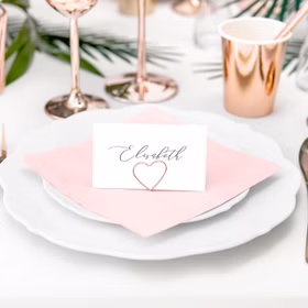 Tischkartenhalter Herzen Roségold 10 Stück Platzkartenhalter Hochzeit Geburtstag SALE Fotohalter Rosé Tischdeko Taufe Jugendweihe Kommunion Tisch-Deko Dekoration Zubehör Platzkarte mit Herzhalter auf weißem Teller und rosafarbener Serviette bei einer Feier.