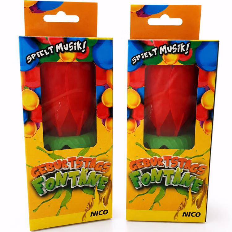 Nico Geburtstagsfontäne 2er Set Verpackung Zwei NICO Geburtstagsfontänen mit Musik im 2er Set in bunter Verpackung mit sichtbarer roter Kerzenblume für Geburtstage.