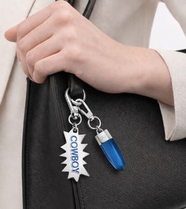 Fashionable Calvin Klein Downtown Charm Set: Stainless Steel Pendants with Contrasting Resin and COWBOY Logo - Bag Accessories - 7 x 1.3 cm - KJJCLA090300 - Silver/Blue