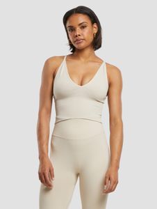 Sujetador deportivo moderno de la marca aim'n, elástico y de color beige.