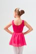 Ein junges Mädchen in einem leuchtend rosa Ballett-Outfit steht mit den Händen in den Hüften und blickt von der Kamera weg. 2