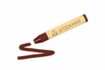 Ein STOCKMAR Wachsmalstifte Einzelstift in braun von Stockmar ruht auf einer weißen Fläche neben dessen Spitze eine braune Wellenlinie gezeichnet ist. venetianischrot