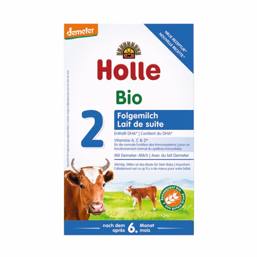 Holle Bio-Folgemilch 2 nach dem 6. Monat_21162 Eine Schachtel Holle Bio-Folgemilch 2 nach dem 6. Monat mit einer Kuh-Illustration Demeter-Logo und deutschem und französischem Text auf der Verpackung geeignet für Babys ab 6 Monaten.