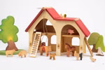 Das Decor Bauernhaus (30 x 33 x 15 cm) ist eine hölzerne Spielzeugscheune mit rotem Dach begleitet von kleinen hölzernen Tierfiguren einer Leiter einem Baum und einem Strauch die alle vor einem weißen Hintergrund stehen.