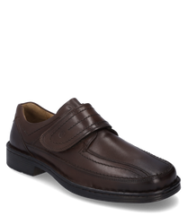 The half shoe made of dark brown leather features a practical Velcro closure. The fine stitching and robust sole give the shoe an elegant yet comfortable appearance.