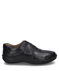 Black leather shoe with Velcro closure. The shoe is characterized by its simple design and robust stitching details.