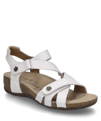 White sandal with Velcro made of smooth leather. Features include decorative metal buttons in flower shape and a comfortable cork sole with a slight elevation.