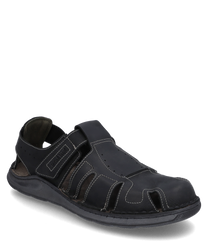 Black leather sandal with Velcro closure. The design features open side slits and a sturdy sole ideal for comfort and ventilation.