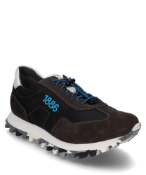 The sneaker is made from a combination of black fabric and brown suede featuring blue laces. Notably the blue number "1886" is displayed on the side and the white sole provides a serrated profile for better grip.