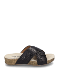 The sandal is made of black woven material and has no closure. It features a beige sole with light brown speckles that provide a natural look.