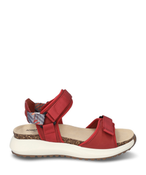 Red sandal with Velcro closure made from durable material. The sole is white and ergonomically shaped featuring a comfortable footbed and a patterned heel strap for added support.