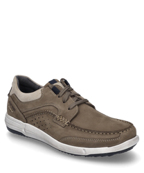A sporty low shoe made of brown leather with lacing and contrasting light stitching. The shoe features a white sole and subtle perforations on the side for additional breathability.