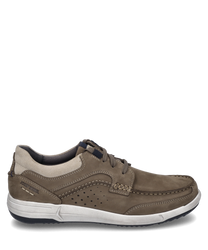 A sporty low shoe made of brown leather with lacing and contrasting light stitching. The shoe features a white sole and subtle perforations on the side for additional breathability.