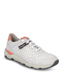 The sneaker is made of smooth cream-colored leather with a perforated design and orange accents. It features lacing and a sturdy beige sole for optimal support and comfort.