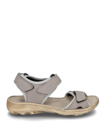 Gray sandal with Velcro closure made of soft leather. The sole is beige and ergonomically shaped ideal for comfort and everyday use.