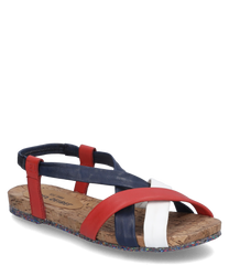 La sandale se distingue par des sangles colorées croisées en rouge bleu et blanc fabriquées en cuir lisse. Elle est dotée d'une boucle et d'une semelle en liège confortable avec un dessous coloré et texturé.