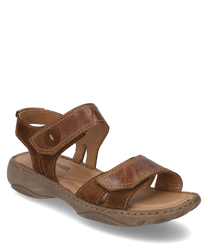 The sandal shown is in a warm brandy color and is made of shiny leather. It features a practical Velcro closure that ensures a comfortable fit.