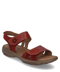 La sandalia está hecha de cuero rojo y cuenta con un práctico cierre de velcro. El zapato tiene una suela robusta de color marrón claro y ofrece una cómoda experiencia de uso.