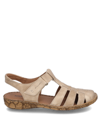 Beige sandal with Velcro closure made of soft leather. The sole features a natural patterned design ideal for comfort and style.
