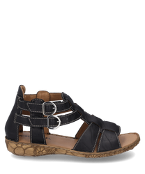 The sandal is made of black leather with two silver buckles as closures. It features a decorative light brown sole with a floral pattern.