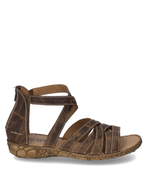Sandale en cuir marron avec couture décorative et fermeture à glissière réglable. La semelle présente un motif floral qui ajoute un charme supplémentaire.