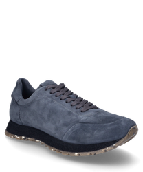 Dark gray suede sneaker with lacing. The sole is patterned and light providing a stylish contrast to the shoe.