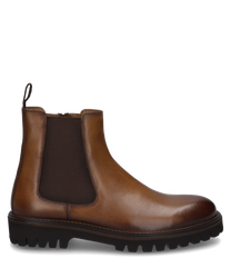 Die Stiefelette aus glattem braunem Leder hat einen seitlichen Reißverschluss für einfaches Anziehen. Sie besticht durch ihre robuste Gummisohle und elastische Einsätze für zusätzlichen Komfort.