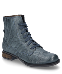 The azure blue leather ankle boot features a side zipper and light brown flat heels. The surface is slightly textured giving the shoe a trendy vintage look.