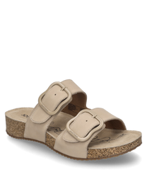 Beige sandal with Velcro closure. The sandal is made of a soft material and features a comfortable light brown sole.
