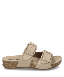 Beige sandal with Velcro closure. The sandal is made of a soft material and features a comfortable light brown sole.