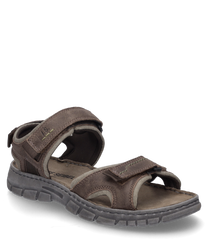 Brown sandal with Velcro closure made from durable leather. The sole is gray and textured for better grip.