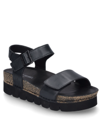 La sandale noire est fabriquée en matériau lisse et dispose d'une fermeture velcro. Elle se distingue par une semelle épaisse et texturée qui allie confort et style.