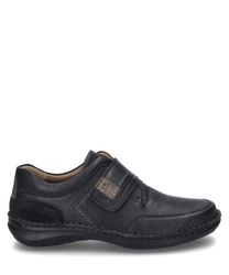 The shoe is black and made of smooth leather with a Velcro strap for easy wear. It features subtle stitching details and a padded collar for added comfort.