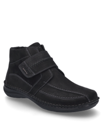 Schwarze Stiefelette aus Leder mit Klettverschluss sichtbaren Nähten und flachem Absatz. Das Innenfutter besteht aus weichem Material für zusätzlichen Komfort.