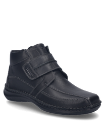 Black leather ankle boot with Velcro closure ideal for a comfortable fit. The shoe features a simple design and durable material.