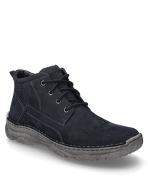 The boots are made of dark blue suede with visible stitching and feature a lace-up closure. They have a sturdy grey sole providing durability and a casual look.