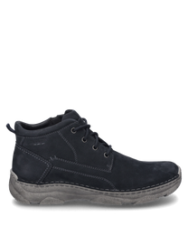 The boots are made of dark blue suede with visible stitching and feature a lace-up closure. They have a sturdy grey sole providing durability and a casual look.