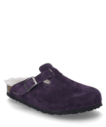 Le sabot de couleur violette est fabriqué dans un matériau doux et velouté et dispose d'une boucle réglable comme fermeture. L'intérieur est doublé d'une peluche claire qui offre un confort supplémentaire.