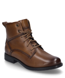 Cognac-colored leather ankle boot with lacing. The shoe features a low heel and visible stitching that adds an elegant touch to the design.