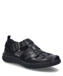 El zapato negro de cuero tiene un cierre de hebilla y una suela robusta. La costura trenzada en el borde y los detalles de corte le dan al zapato un aspecto especial.