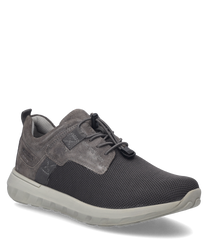 The sneaker in the color asphalt features a combination of smooth and textured materials with lacing as a closure. The sole is in a light shade providing a modern contrast to the darker upper material.