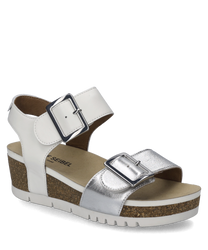 This sandal in silver combination features a practical Velcro closure and is characterized by its shiny silver upper material. The shoe has a comfortable sole with a cork look providing additional comfort.