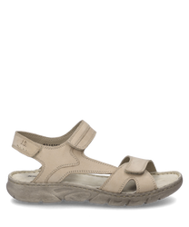 Beige sandal with Velcro closure. The sandal is made of leather and features visible seams that give the design structure.