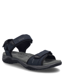 La sandale représentée en couleur indigo est fabriquée à partir d'un matériau robuste et dispose d'une fermeture velcro pratique. La semelle est ergonomiquement conçue pour offrir un confort optimal.