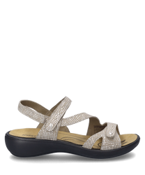 Beige sandal with Velcro closure adorned with a subtle pattern. The sandal has a black sole and provides comfortable support through the straps made of soft material.