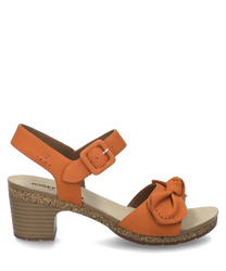 La sandale de couleur papaye est fabriquée dans un matériau lisse avec une fermeture velcro confortable. Elle se distingue par un talon stable et un nœud décoratif sur la sangle avant.