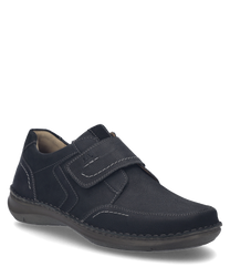The shoe is black and made of a smooth material with visible seams. It features a practical Velcro closure for easy on and off.