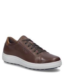 La sneaker de couleur "castagne-kombi" est en cuir lisse marron avec un laçage. Les caractéristiques particulières sont les inserts en cuir brun clair contrastants sur la tige ainsi que la semelle en caoutchouc noire.