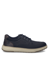 Zapatilla azul oscuro con cordones hecha de cuero suave. El zapato tiene una suela texturizada de color gris claro y detalles marrones en el talón.